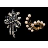 * Brooches. A white metal brooch set with diamonds and sapphires