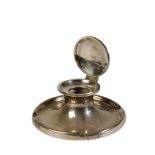 LARGE SILVER CAPSTAN INKWELL with a hinged lid and a dished circular base with four indentations