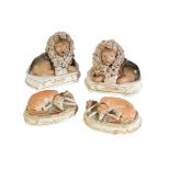 A PAIR OF STAFFORDSHIRE PORCELAIN MODELS OF LIONS, circa 1840, each comically moulded recumbent