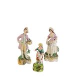 PAIR OF STAFFORDSHIRE POTTERY FIGURES of a gardener and his female companion, painted in