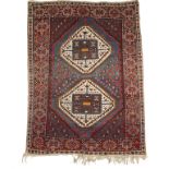 NORTH WEST PERSIAN TRIBAL RUG, the central blue rectangular panel worked with two ivory and