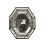 VENETIAN MIRROR with an octagonal principal plate, in a border composed of multiple floral