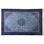 SMALL CHINESE RUG, the pale blue ground with a central geometric design within key pattern corner