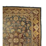 SMALL AGRA CARPET, the blue ground with a central magenta and ivory floral medallion within Hirati