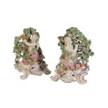 PAIR OF CHELSEA DERBY CHERUB CANDLEHOLDERS, circa 1765, modelled with a bocage background, on