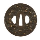 FINE IRON TSUBA, EDO PERIOD, cast in relief with dragons, clouds and pine trees, 8cm wide