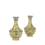 PAIR OF FAMILLE ROSE ENAMEL VASES, LATE QING / REPUBLIC PERIOD, the baluster sides decorated with