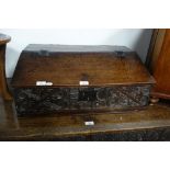 CHARLES II OAK WRITING BOX of boarded construction, the sloping lid with "butterfly" hinges and