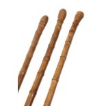 THREE EDWARDIAN BAMBOO OTTER HUNTING STAFFS