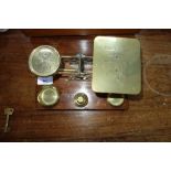 A LATE VICTORIAN BRASS POSTAL SCALE