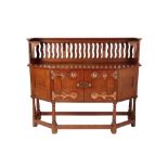 ATTRIBUTED TO LIBERTY & CO: AN ARTS AND CRAFTS OAK SIDEBOARD