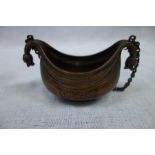 AN EASTERN COPPER HANGING CENSER, of boat form with beast head terminals and engraved