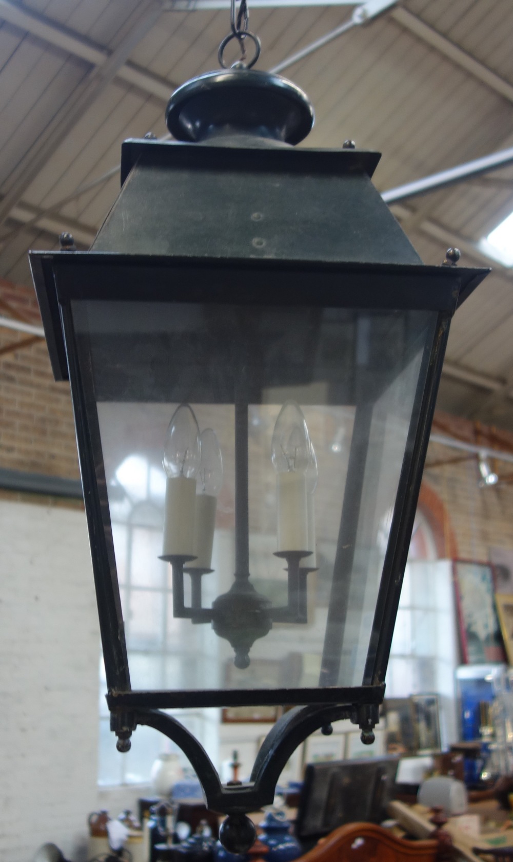 A GREEN PAINTED PORCH LANTERN of traditional design, with four glazed panels, 72cm high (approx)