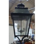 A GREEN PAINTED PORCH LANTERN of traditional design, with four glazed panels, 72cm high (approx)