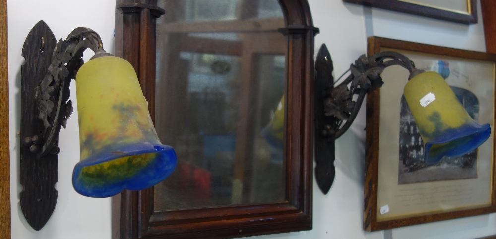 A PAIR OF FRENCH WROUGHT IRON WALL LIGHTS in the style of Edgar Brandt with yellow and blue glass