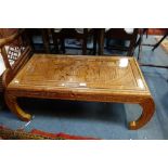 AN INDONESIAN CARVED HARDWOOD LOW TABLE, fitted a glass top, 101cm wide