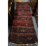 A RED GROUND KELIM RUNNER, 80cm x 245cm (plus fringes)