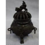 A CHINESE BRONZE CENSER, OF BELLIED FORM, supported by three figures, with ring handles and