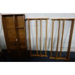 ERCOL: A pale elm hanging plate rack with panelled back and a pair of pale elm plate racks