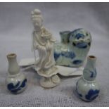 A CHINESE BLUE AND WHITE BRUSH HOLDER IN THE FORM OF A LION, a miniature 'blanc de Chine' figure,