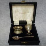 A MATCHED SILVER PLATED CHRISTENING SET, comprising egg cup, spoon and napkin ring.