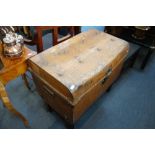 A VINTAGE TIN TRUNK containing wooden brushes, two marble dishes and sundries