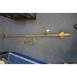 A VICTORIAN BRASS CURTAIN POLE, 195cm long and two pairs of brass curtain tie-backs