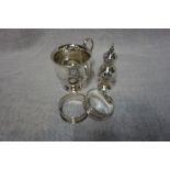 A SILVER CHRISTENING MUG, a silver pepperette and two silver napkin rings (c. 2.8oz) (4)