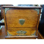A 19TH CENTURY OAK STATIONARY CABINET with brass fittings, 28cm high
