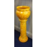 A BURMANTOFT'S FAIENCE ORANGE GLAZED JARDINIERE ON STAND, 85cm high (overall)