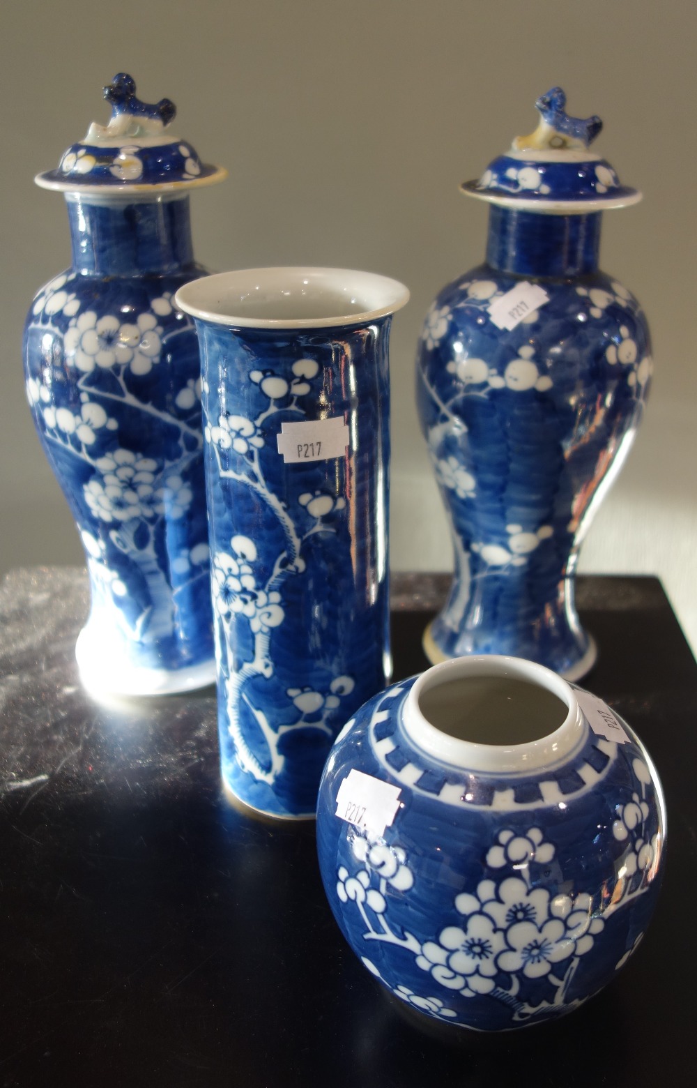 A PAIR OF ORIENTAL BLUE AND WHITE PRUNUS VASES, with lids, a cylinder vase and a ginger jar