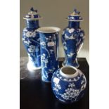 A PAIR OF ORIENTAL BLUE AND WHITE PRUNUS VASES, with lids, a cylinder vase and a ginger jar
