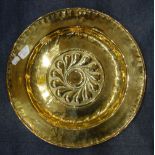 AN 18TH CENTURY BRASS CHARGER/ ALMS DISH with embossed and engraved decoration, dated '1740'