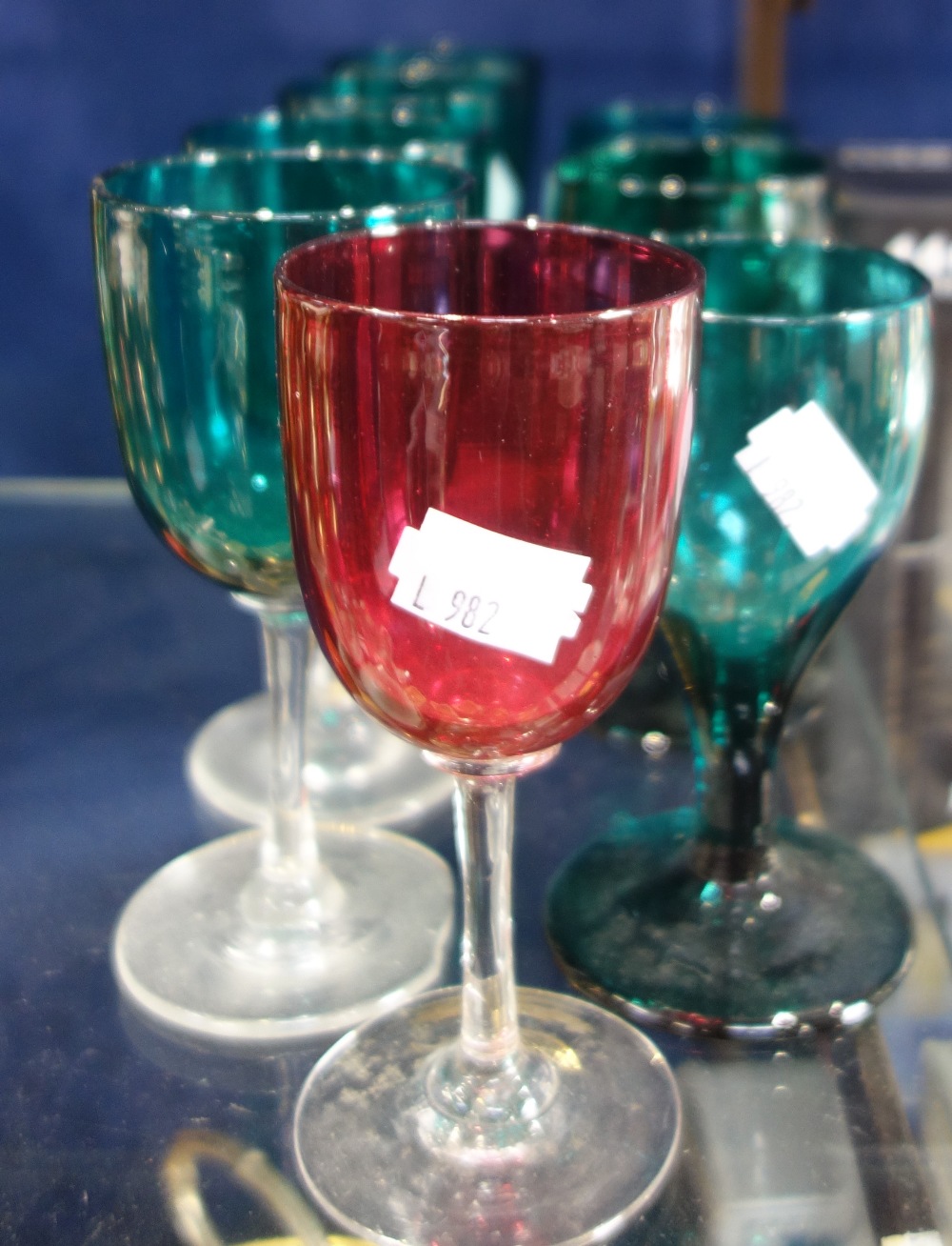 A COLLECTION OF VICTORIAN GREEN GLASSES and a cranberry glass