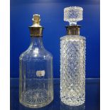 A CUT GLASS DECANTER with a silver collar and another similar (2)