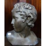 A BRONZE EFFECT PLASTER BUST OF A BOY, 35cm high