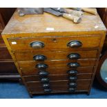 AN EARLY 20TH CENTURY GRAINED PINE CHEST OF SEVEN SHALLOW DRAWERS, from an engineering workshop,