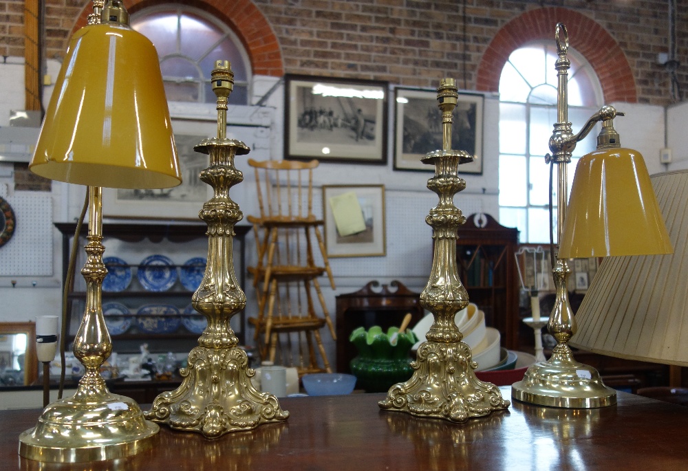 A PAIR OF ROCOCCO BRASS TABLE LAMPS and a similar pair with orange glass shades