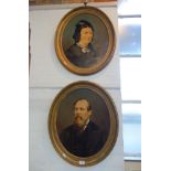 A PAIR OF VICTORIAN OVER-PAINTED PHOTOGRAPHIC PORTRAITS of a lady and gentleman, in oval gilt