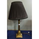 A BRASS CORINTHIAN COLUMN ELECTRIC TABLE LAMP with a pleated shade, (46cm high plus fitting)