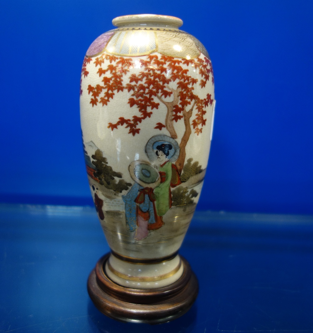 A JAPANESE SATSUMA VASE, MARKED, painted and gilt, 15 cm high, with wooden stand