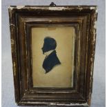 AN EARLY 19TH CENTURY SILHOUETTE of a gentleman, in a fitted frame