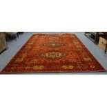 A LARGE RED GROUND PERSIAN RUG, 253cm x 347cm