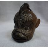 A TIBETAN POTTERY BELL, in the form of a monkey's head