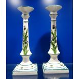 A PAIR OF GRISELDA HILL POTTERY 'WEMYSS' CANDLESTICKS, decorated with thistles, 33cm high