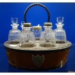 A 19TH CENTURY CRUET in a light oak stand with plated fittings, each etched glass bottle in barrel