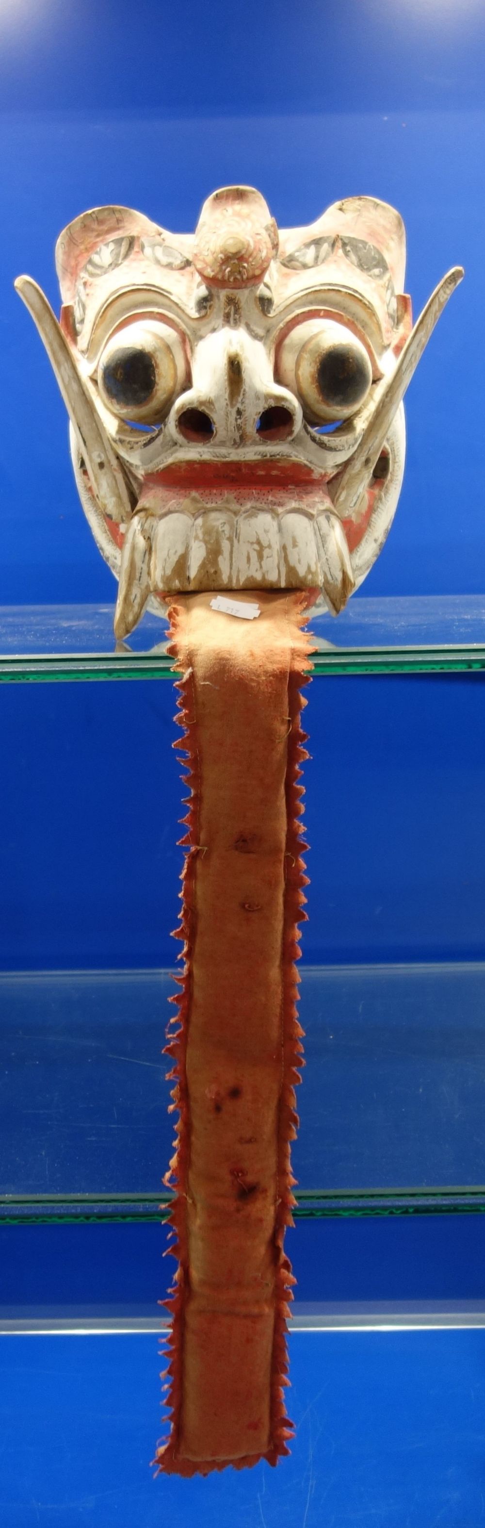 A CARVED AND PAINTED WOODEN MASK, Indonesia, 19th century, depicting Rangda (the Witch), 23cm high ,