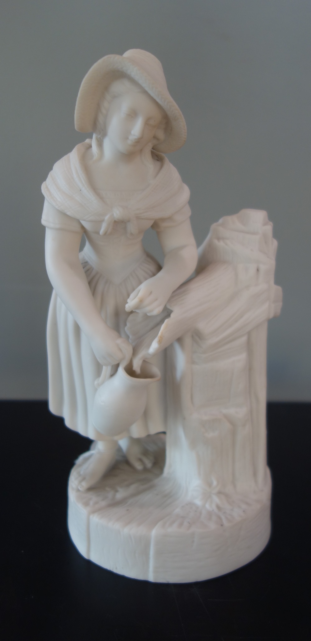 A VICTORIAN PARIAN WARE STUDY OF A WOMAN COLLECTION WATER, 25.5cm high