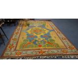 A LARGE TURKOMAN RUG of geometric design and bright colouring, 208cm x 320cm (plus fringes)