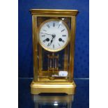 A FOUR-GLASS BRASS CASED MANTEL CLOCK, WITH MERCURY PENDULUM, CIRCULAR ENAMEL DIAL AND 'C.J & Co'